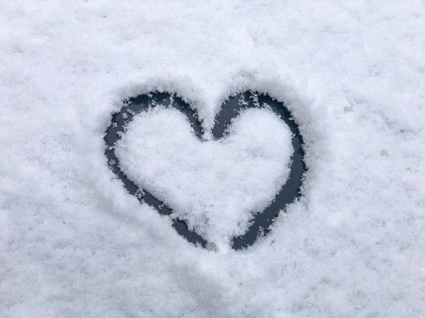 istock hand drawn heart shape on snowy background in winter 1366783841