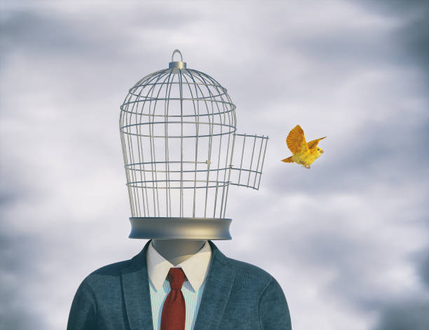 istock Businessman with a bird cage head and a canary flying off. 1366784021
