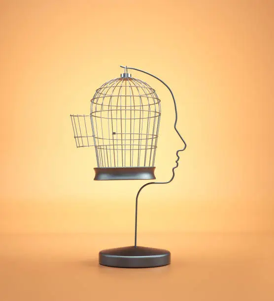 Bird cage opened shaped as a human head. Escape and mindset concept.  This is a 3d render illustration