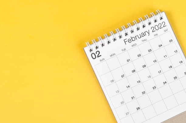 istock February 2022 desk calendar on yellow background with empty space. 1366785491