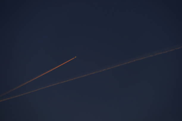Jet Stream at Sunrise. Bavaria, Germany. Bavaria, Germany. Jet Stream at Sunrise. contrail moon on a night sky stock pictures, royalty-free photos & images