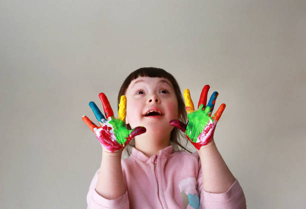 istock Cute little kid with painted hands. Isolated on grey background. 1366787569
