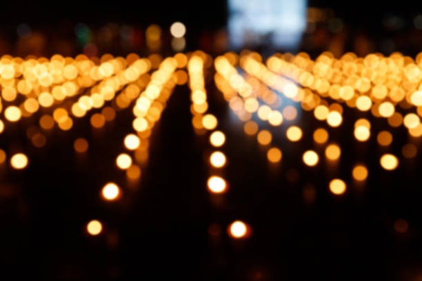 Abstract golden bokeh from candle light on black background.