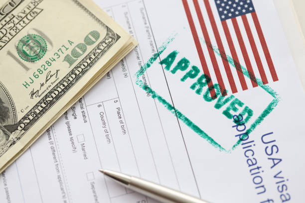 istock Stamp approved is on documents for obtaining American visa closeup 1366793232