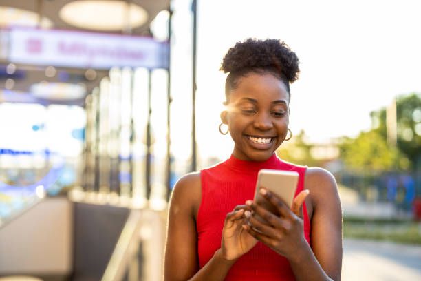 istock Young woman using mobile phone outdoors 1366793880