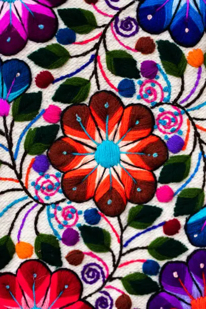Craft fair: abric with embroidery in the form of colorful flowers
