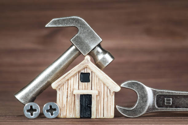 istock Miniature wooden house model and hand tools 1366794467