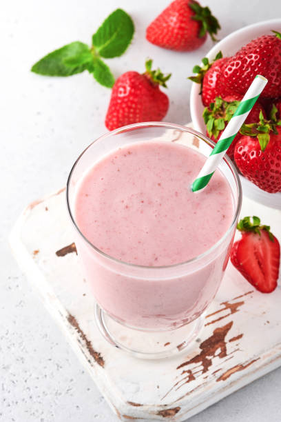 fruit smoothie. strawberry smoothie or milkshake with berries and mint in tall glass on light grey background. summer drink shake, milkshake and refreshment organic concept. place for text. - healthy eating food and drink nutrition label food imagens e fotografias de stock