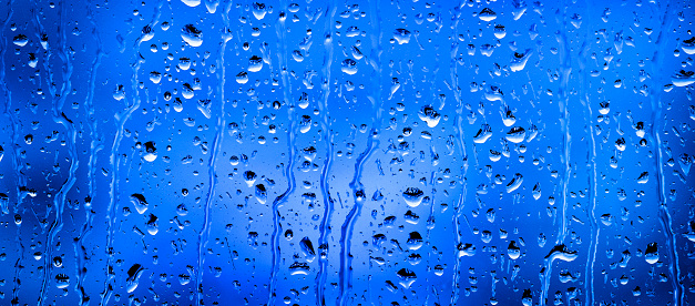 Window with rain or water drops from stormy weather