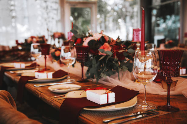 Romantic red table, decorated table with flowers and red candles. Luxury Christmas evening or wedding party decoration. Beautiful, decorated table with flowers and red candles. Luxury Christmas evening or wedding party decoration. rose bouquet red table stock pictures, royalty-free photos & images