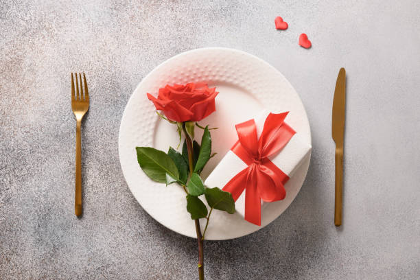 istock Valentine's day festive dinner with red rose and romantic gift 1366799996