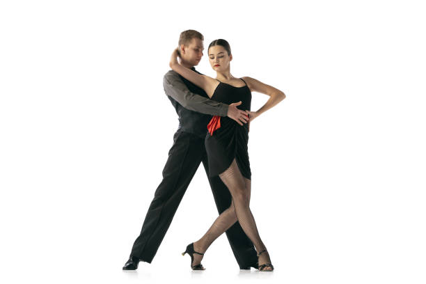 istock Grace and beautiful dancers, young couple dancing Argentine tango isolated on white studio background. Artists in black stage costumes 1366800069