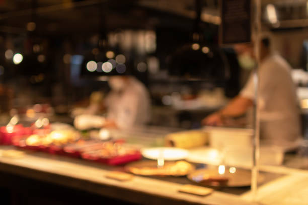 Blurred image for background of chef cooking in a open kitchen in restaurant. stock photo