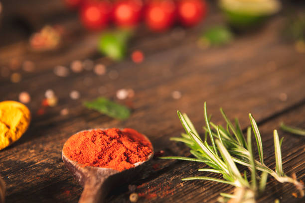 Spices and herbs on rustic wooden table with copy space