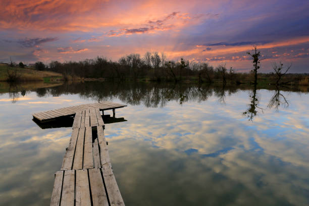 istock wooden bridge on sunset lake 1366802867