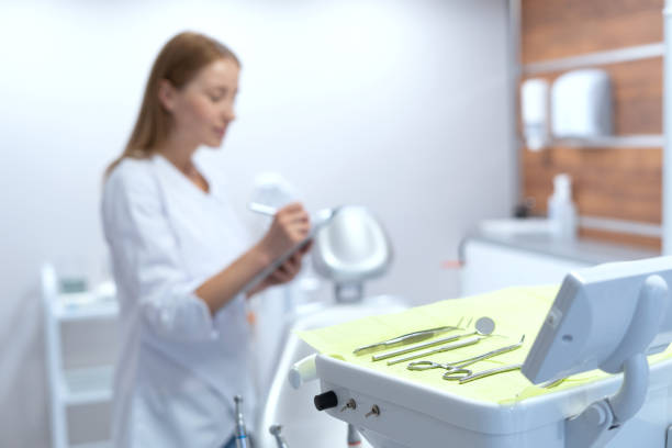 istock Dentist making notes in modern stomatology clinic office 1366802972