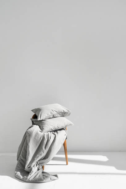 istock Clean bedding lying on chair ready for laundry 1366803194