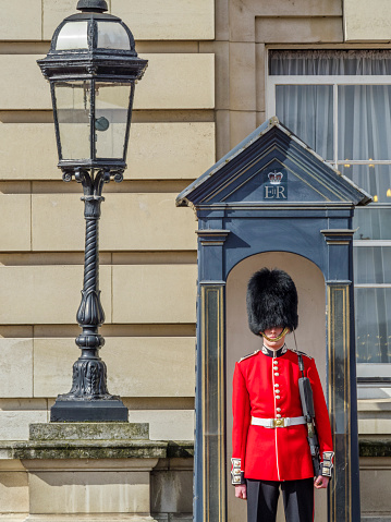 The City of London England on April 12, 2016:  The Queen's Guard in full dress uniform at the entrance to Buckingham Palace in London England