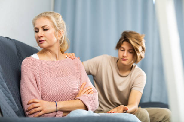 istock Mother and son sitting after quarrel at home 1366808834