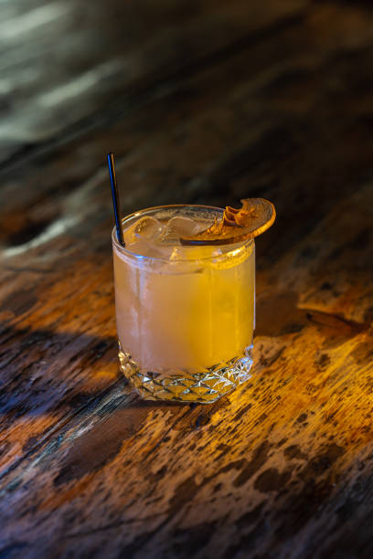 istock Old fashioned cocktail with apple on the wooden background 1366809663