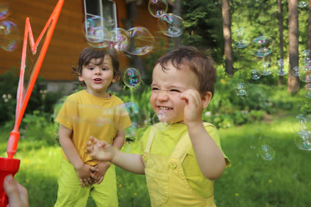 istock Small children play with soap bubbles. 1366811020