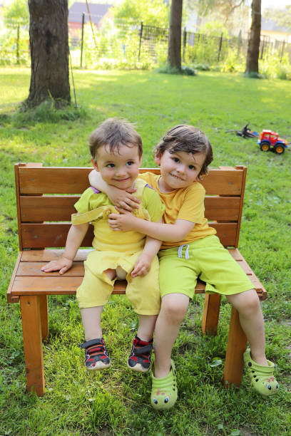 istock Little brothers communicate on a bench. 1366811024