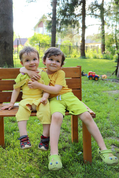istock Little brothers communicate on a bench. 1366811059