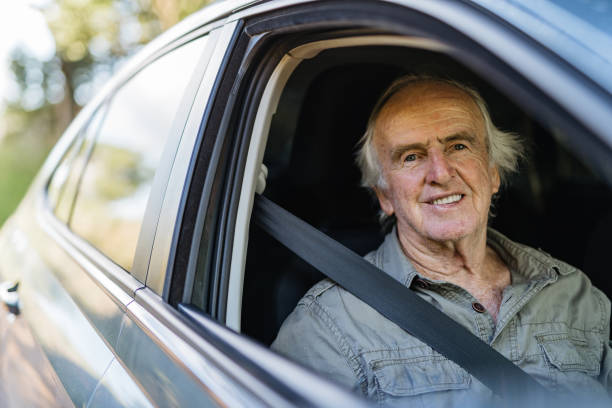 istock Senior man in car passenger seat 1366811098