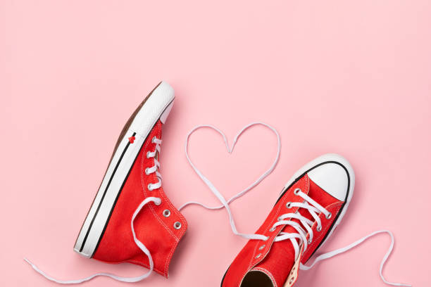 istock Minimal composition with red sneakers on pink background 1366812210