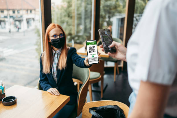 istock Young woman showing Coronavirus electronic pass 1366812404