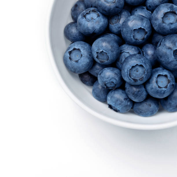 istock Fresh blueberries in bowl isolated on white. Top view. 1366812513
