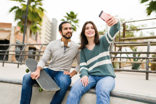 istock Attractive multiracial friends with a skateboard 1366813738