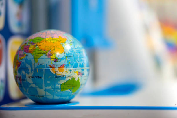 istock A blue toy globe rests on a student's desk. 1366813995