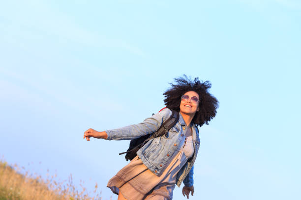 istock African female backpacker, hiking in countryside 1366814287