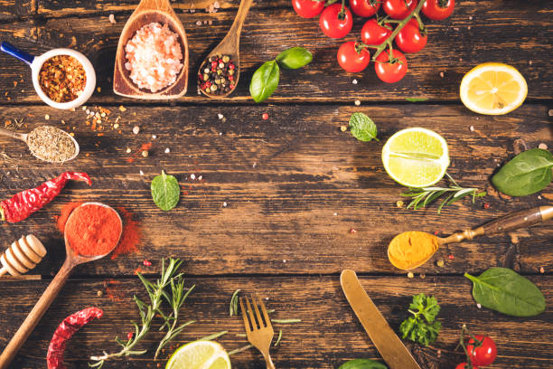 Spices and herbs on rustic wooden table with copy space
