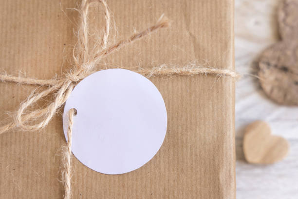 istock Valentines present with round blank gift tag and hearts top view, Rustic label Mockup 1366816187