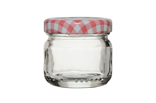 Empty glass jar, closed with a metal lid. Isolated on a white background.