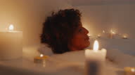 istock Woman Enjoying a Candlelight Bath 1366819082