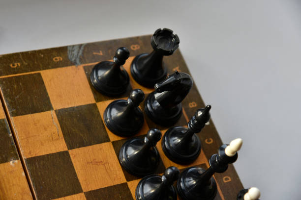 istock An old chessboard with white and black pieces 1366819688