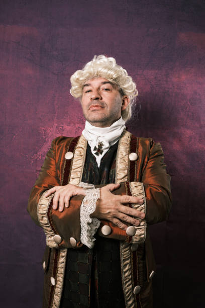 istock Serious man in classic renaissance clothes posing over an isolated background. 1366819723
