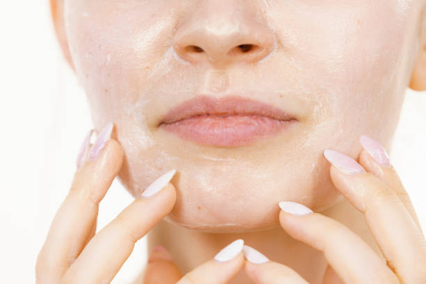 istock Girl with cream moisture cosmetic on face 1366820704