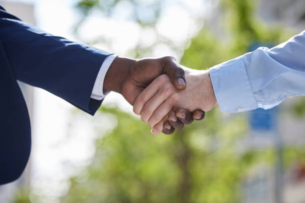 istock Shot of two unrecognizable businesspeople sharing a handshake outside 1366820930
