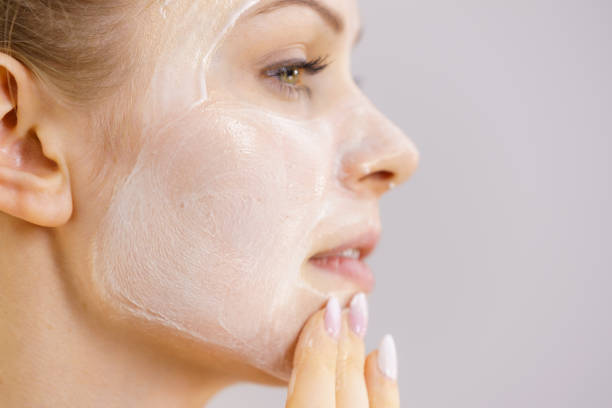 istock Girl apply cream cosmetic 1366820972