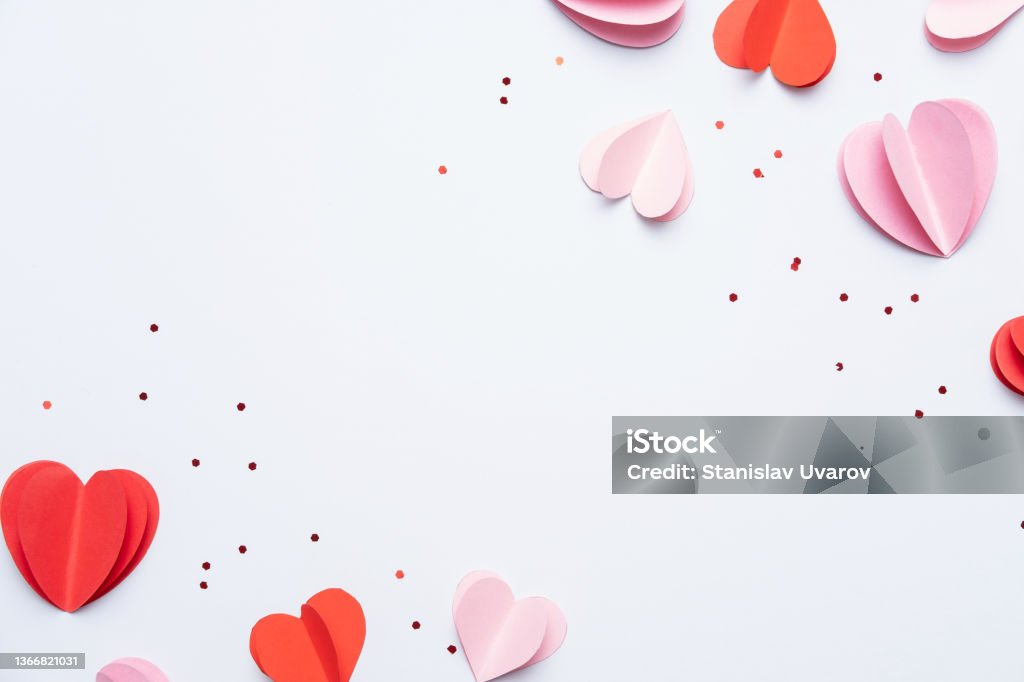 Paper elements in shape of hearts on white background. Symbols of love for Happy Women's, Mother's, Valentine's Day, birthday. Top view of greeting card. Flat lay Valentine's Day - Holiday Stock Photo