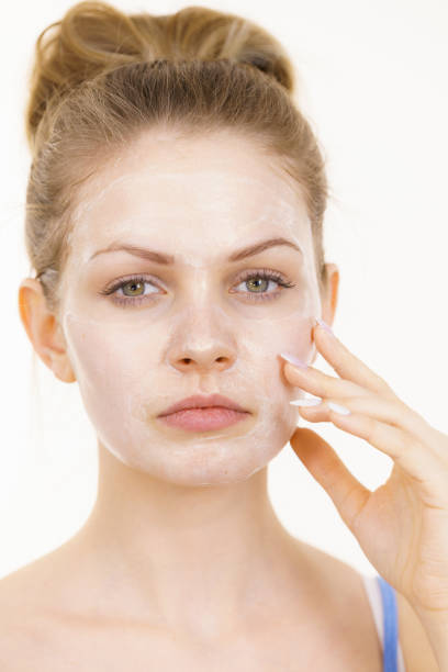 istock Girl with cream moisture cosmetic on face 1366821295