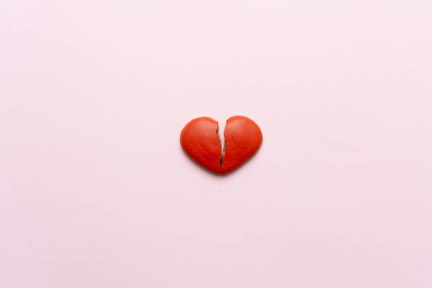 istock Red broken heart on pink background. 1366821327