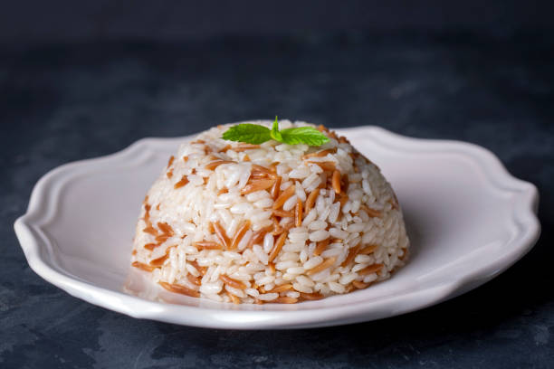 Traditional delicious Turkish food; Turkish style rice pilaf (Turkish name; Arpa sehriyeli pirinc pilavi) Traditional delicious Turkish food; Turkish style rice pilaf (Turkish name; Arpa sehriyeli pirinc pilavi) ARPA stock pictures, royalty-free photos & images