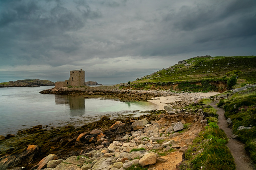 Cromwell's Castle in coastline on Tresco island in the Isles of Scilly. England