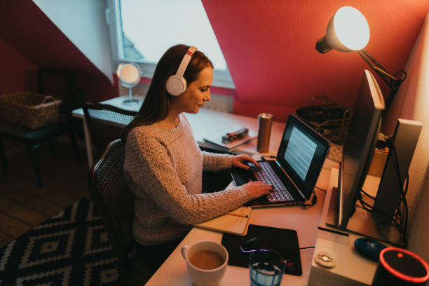 istock Young woman using a laptop and working from home 1366823384