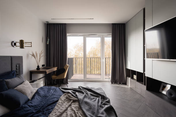 Spacious bedroom with big tv and desk